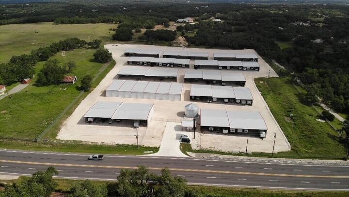 Aerial view of covered boat and RV storage facility near Bulverde, Texas with secure gated entry and spacious parking units along TX-46